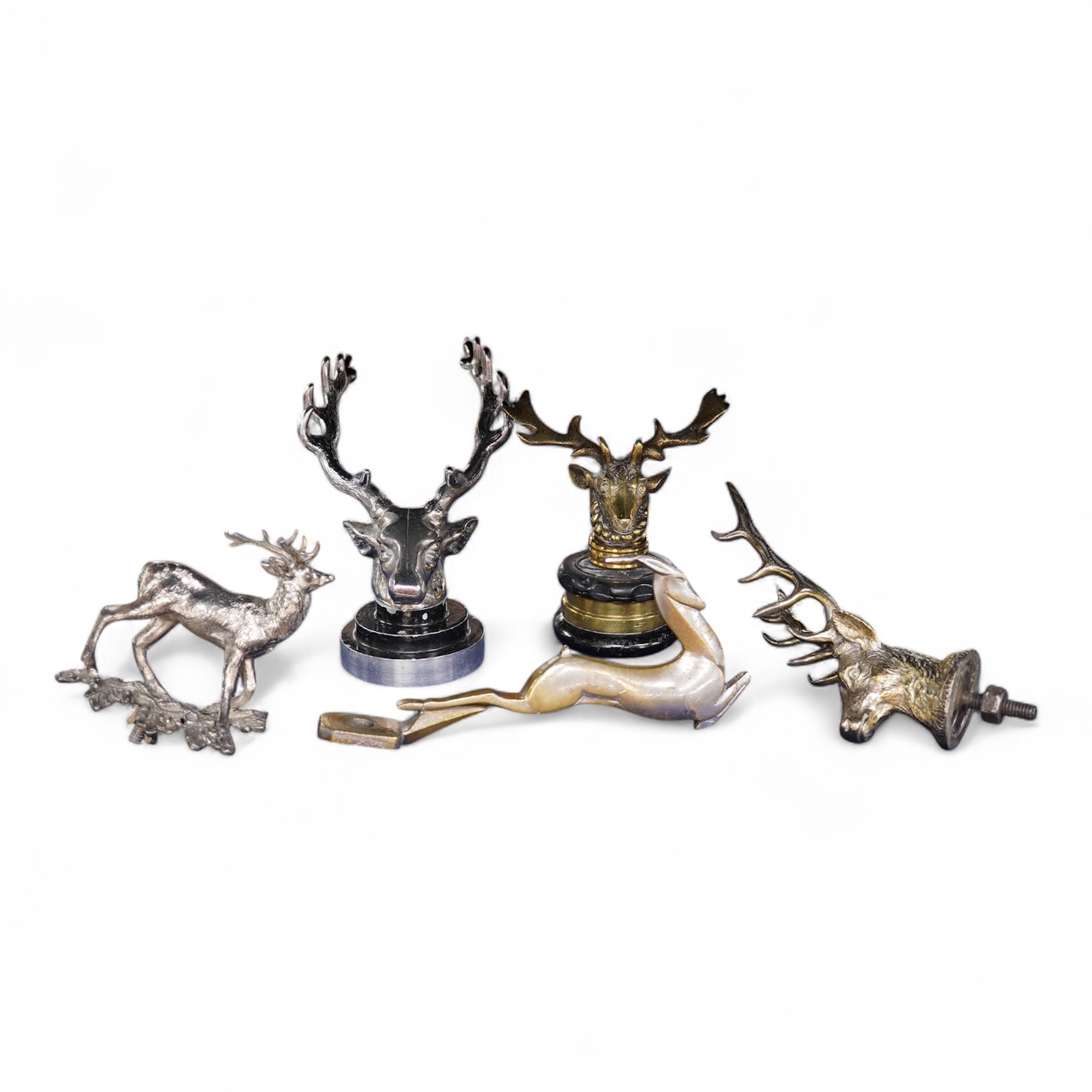 Five chrome and brass car radiator mascots; three in the form of stags’ heads, a stag standing on an oak branch and an Art Deco leading gazelle. Condition - fair, some losses to chrome plating.